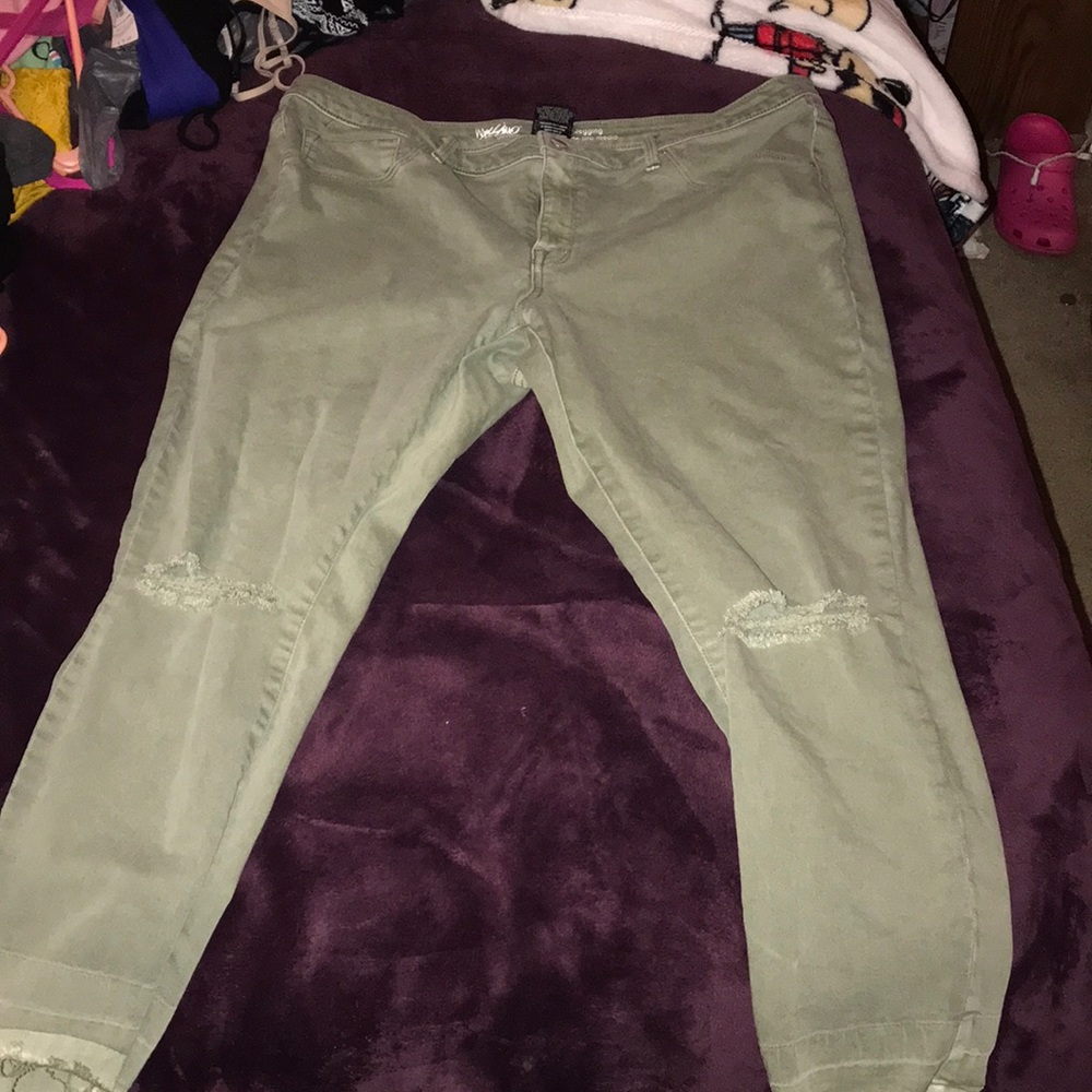 Army green jeans with cuts at the knees